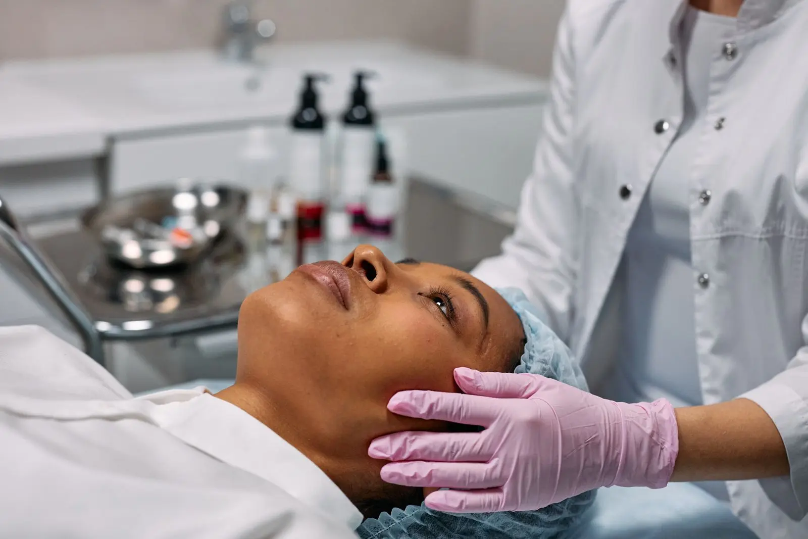 Profissional realizando avaliação facial em ambiente clínico